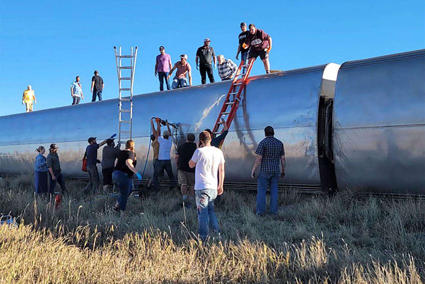 train with people on top and ladders on side